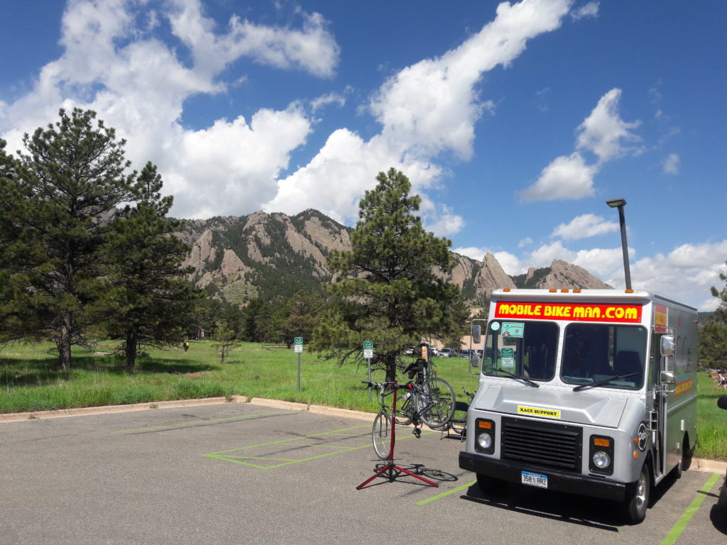 Mobilebikeman.com mobile bike repair shop at park in with Flatirons in the background.